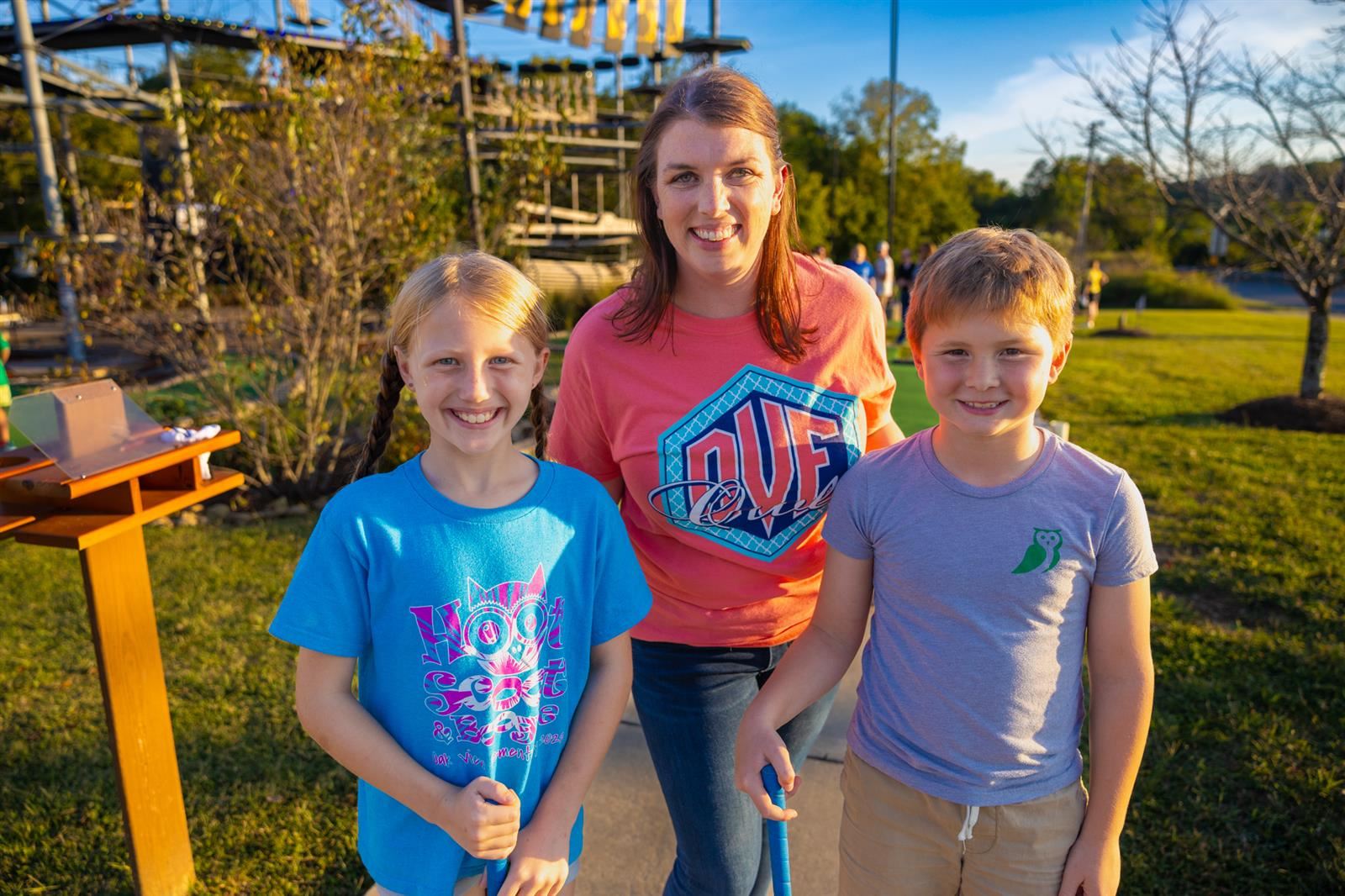 teacher and two students at mini golf event